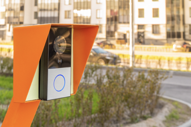 Modern video intercom panel with camera and call button installed at building entrance